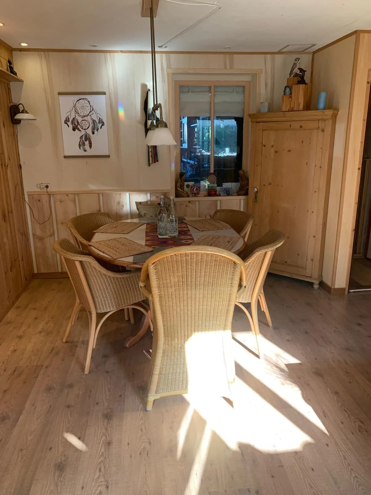 Ronde tafel met rotan stoelen in een warme houten ruimte
